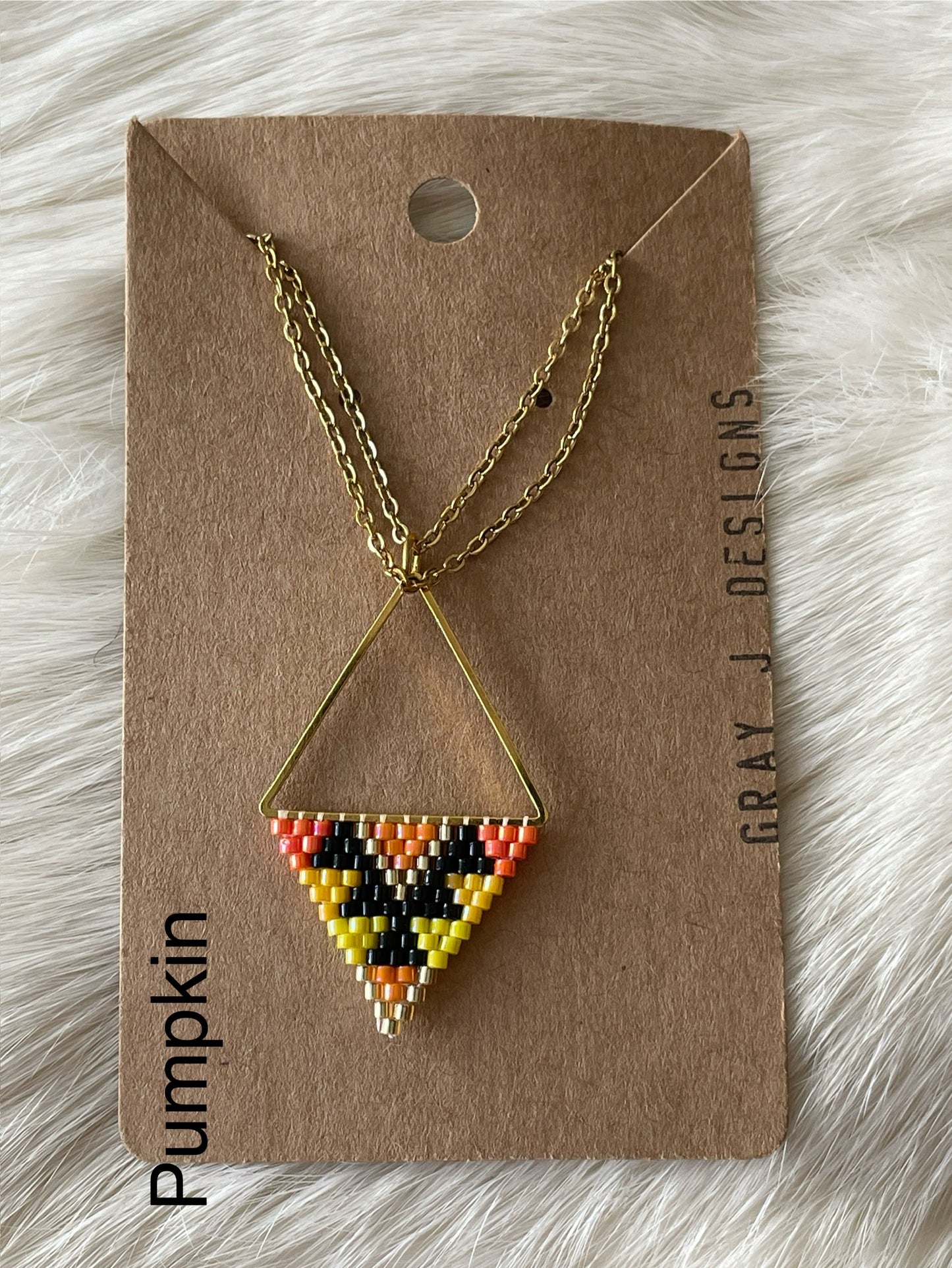 Beaded pendant on metal