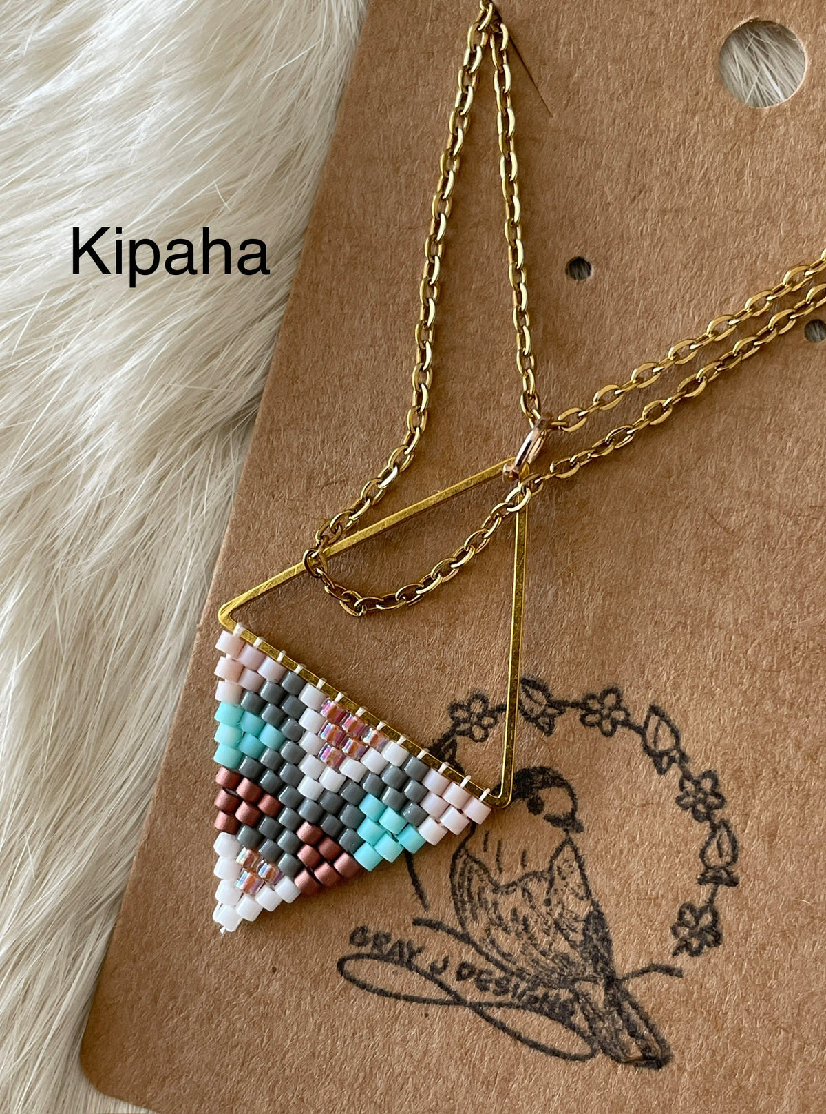 Beaded pendant on metal