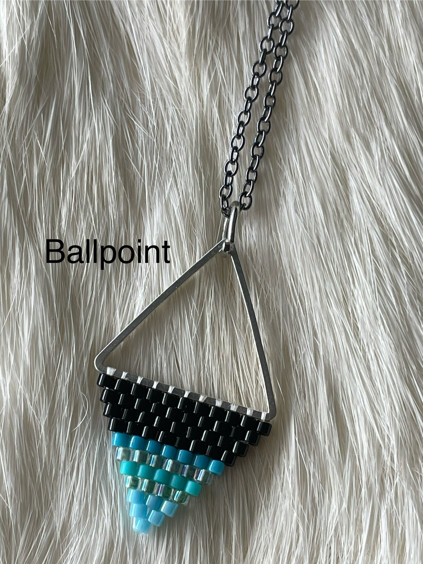 Beaded pendant on metal