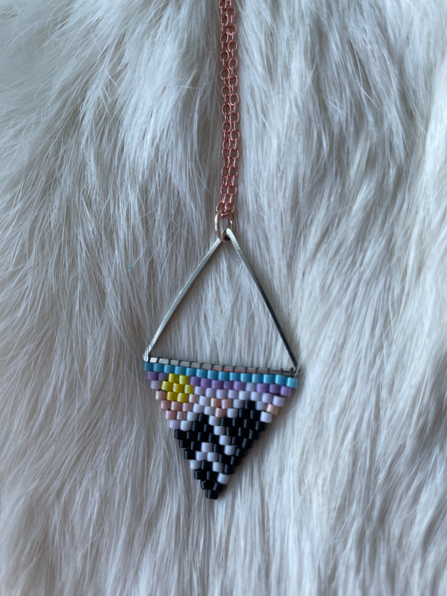 Beaded pendant on metal