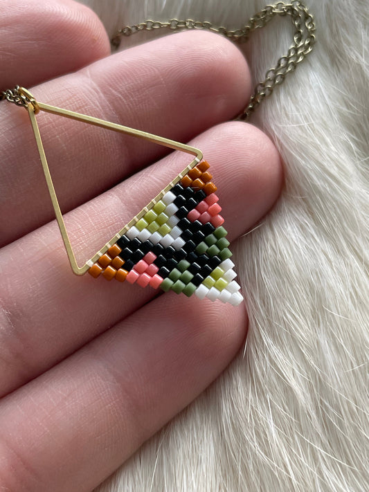 Beaded pendant on metal